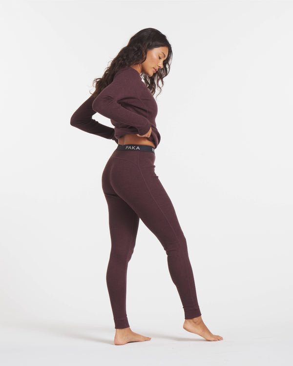 Side Shot of Woman in Uva / Dark Purple Alpaca Wool Thermal Baselayer Top and Bottoms for Skiing – PAKA Apparel