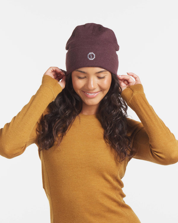 Woman Smiling Adjusting Beanie in Golden Brown Alpaca Wool Thermal Long Underwear Top – PAKA Apparel