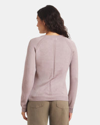 Woman wearing a light purple sweater on a white background