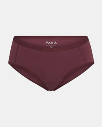 Front view of Women’s Essential Boy Short in raisin showing mid-rise full coverage with PAKA label on light gray background