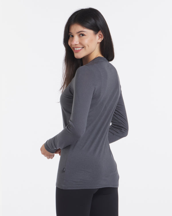 Model Smiling Looking Over Shoulder in Aire Charcoal Blue Women’s Lightweight Long Sleeve Shirt – PAKA Apparel