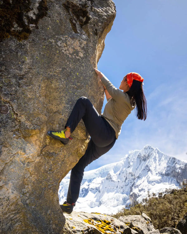Woman Climbing Rock in Aire Eucalyptus / Green Moisture Wicking Long Sleeve Shirt with Mountains in Background – PAKA Apparel