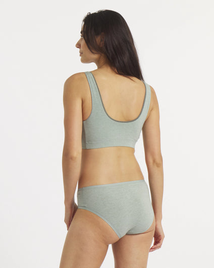 Woman wearing a green bikini set on a white background