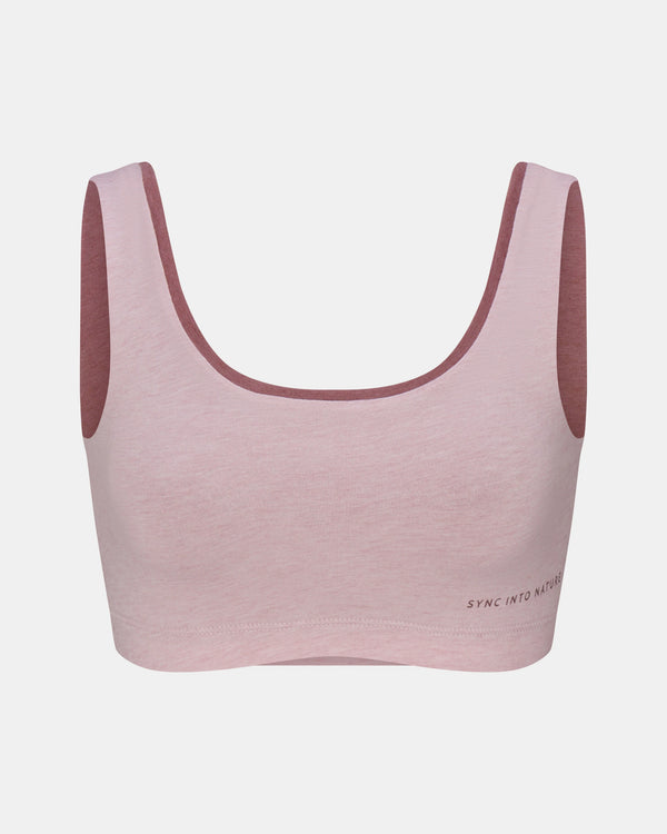 Pink sports bra with maroon straps on a light gray background