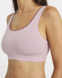 Pink sports bra with 'Sync Into Nature' text on a white background