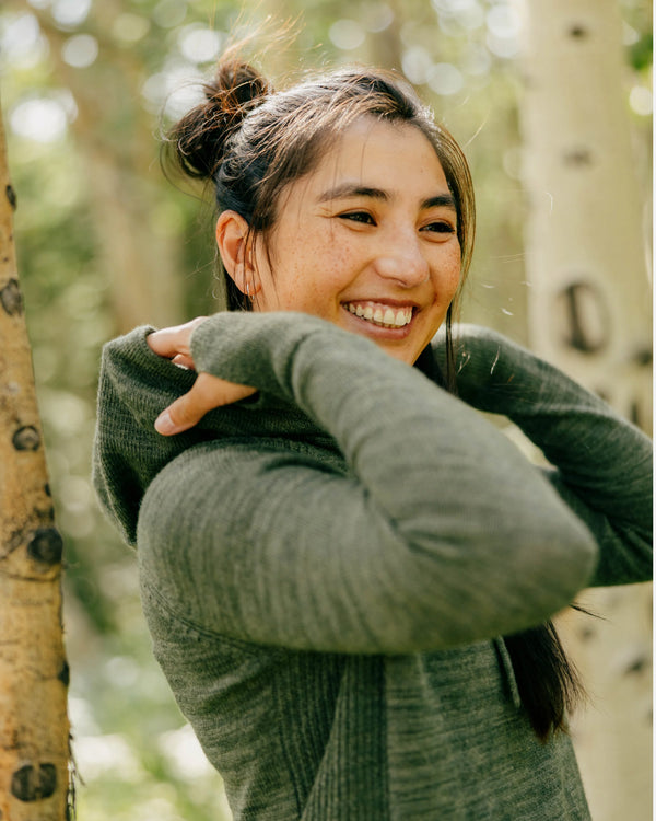 Woman hugging herself in a forest setting