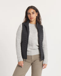 Front three-quarter of Women’s Mayu Ultralight Vest in black on model, showing quilted packable puffer and zip pockets