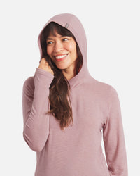 Front view of Women’s Sol Hoodie in Woodrose on model with hood up and visible thumbhole, regular fit, white background