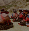 Peruvian women weaving colorful textiles outdoors in traditional clothing