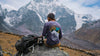 A man wearing a purple Explore Peru long sleeve in front of the Ausangate mountain