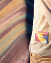 The Explore Peru label on one of our timber shirts in front of the Rainbow mountain