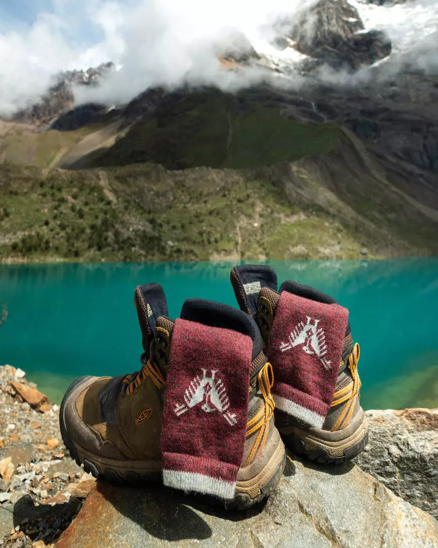 Our Condor socks in front of a mineral blue lake