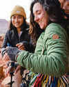 Two ladies smiling, wearing our Pakafill puffer jackets