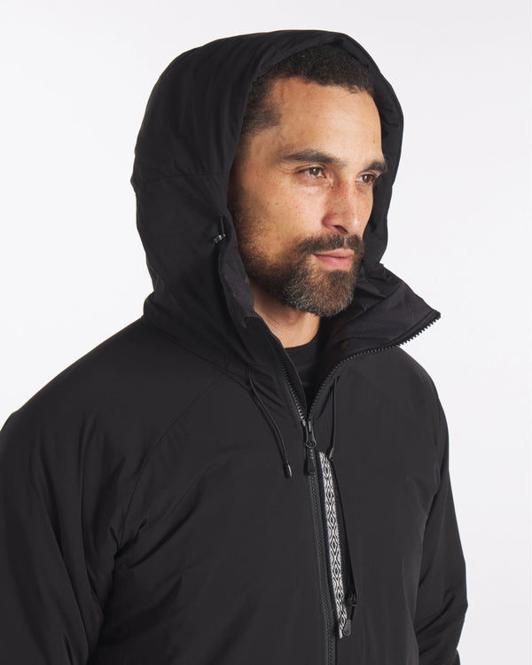 Model with Hood Up in Apu Men's Black Water Repellent Parka Winter Ski Jacket with Natural PAKAFILL® Insulation – PAKA Apparel