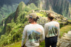 Couple standing in Paka shirts overlooking Machu Picchu 