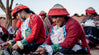 A group of Quechua women weaving alpaca bracelets