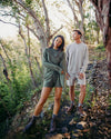 Man and woman standing in woods wearing alpaca terry crew and shorts 