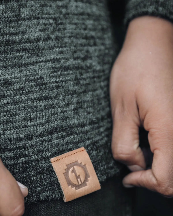 Close-Up of PAKA Logo on The Hoodie Charcoal / Dark Grey Alpaca Hooded Pullover Sweater on Man – PAKA Apparel