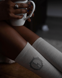 Ivory / White Alpaca Wool Crew Socks on Legs of Woman Drinking Coffee – PAKA Apparel