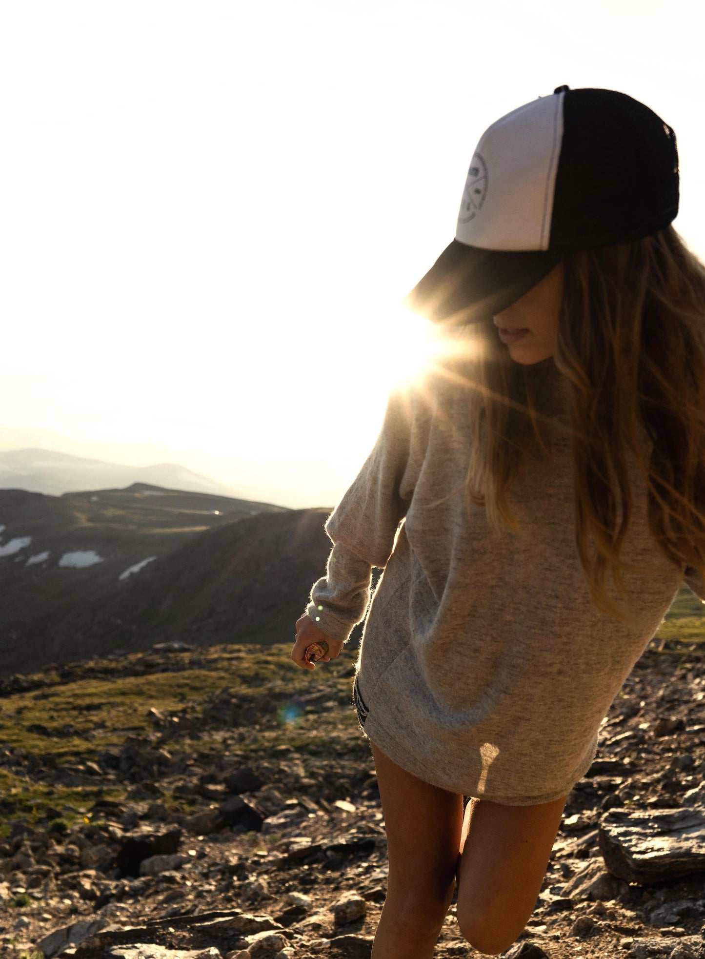 Girl wearing Paka Hoodie during sunset in mountains