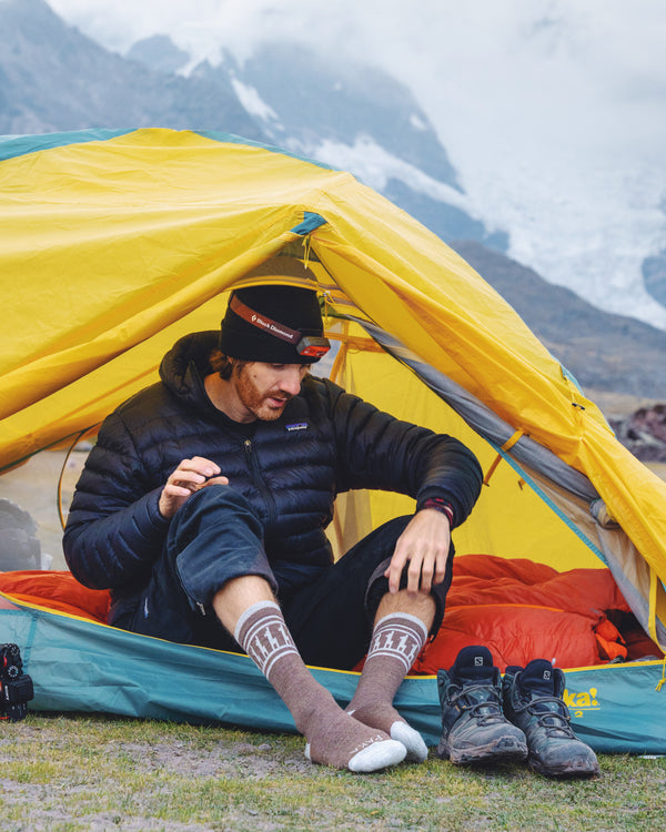 Brown alpaca wool sock with alpaca design on man