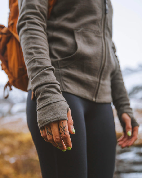 Woman wearing green alpaca wool hoodie with thumb holes