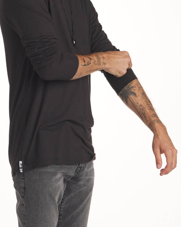 Tattooed Man Rolling Up Sleeves of Black Aire Sustainable Alpaca Long Sleeve Shirt – PAKA Apparel