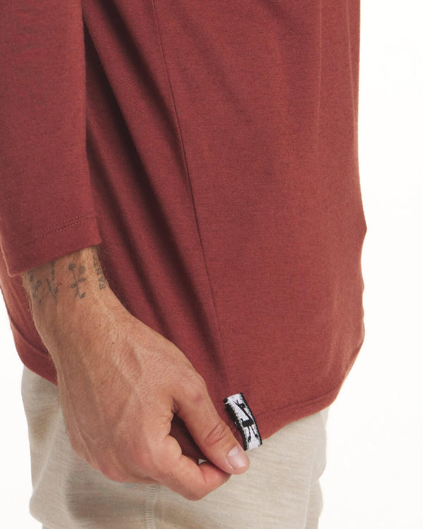 Close Up of Alpaca Tag at Waist of Clay / Red Aire Men's Moisture Wicking Long Sleeve Shirt – PAKA Apparel