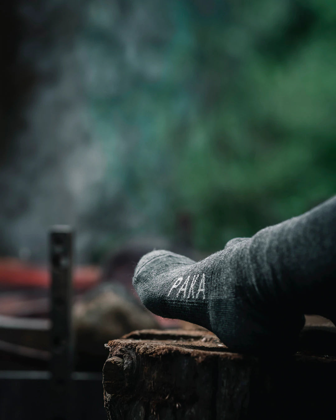 Close-up of dark grey Paka socks at campfire