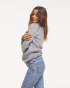 Woman with Arms Cozily Wrapped in The Costa Gray Peruvian Alpaca Merino Wool Blend Crew Sweater – PAKA Apparel
