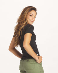 Woman Looking Over Shoulder Toward Camera in Black Organic Pima Cotton and Alpaca T-Shirt – PAKA Apparel