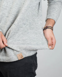 Man's Hands Pulling at Waist of The Original Crew Alpaca Crewneck Sweater in Light Grey – PAKA Apparel