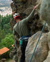 Men's green alpaca wool base layer on rock climber